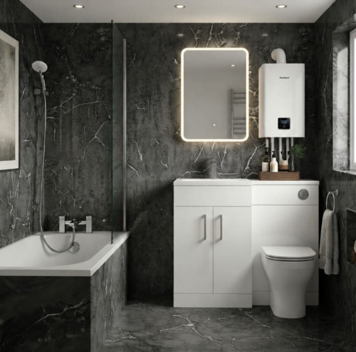 Bathroom renovation with dark marble tiles, bath, vanity unit and wall-mounted boiler